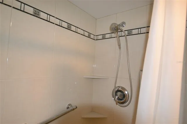 a bathroom with a shower and a window