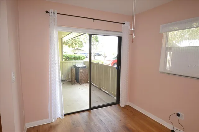 a view of a small space with wooden floor and a window