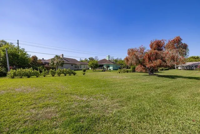 a view of a field with houses in background