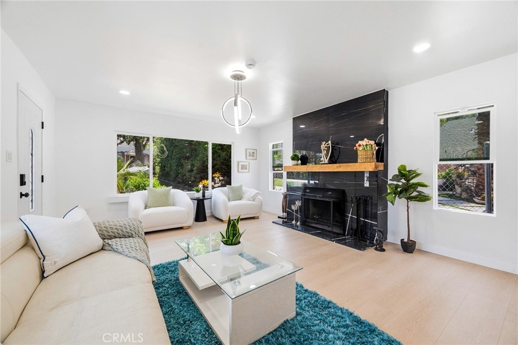 1280 East Woodbury Road Pasadena, CA 91104 - Photo 10 of 40 a living room with furniture and a fireplace