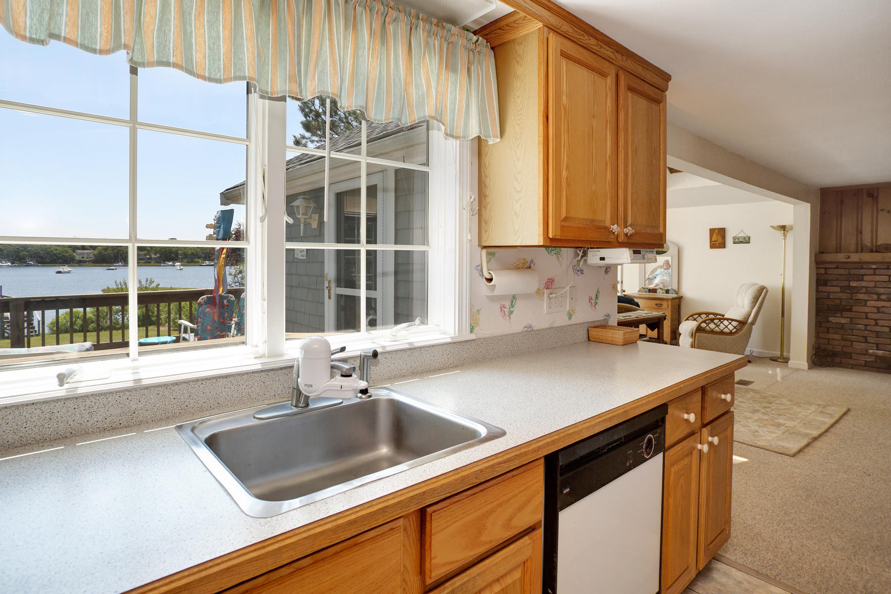 256 Monomoscoy Road Mashpee, MA 02649 - Photo 12 of 28 a kitchen with a sink and a window