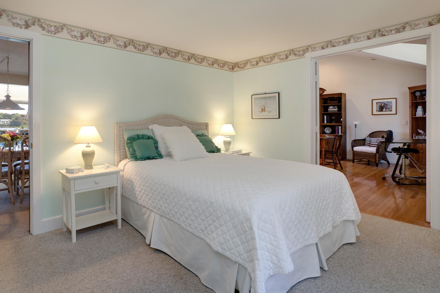 256 Monomoscoy Road Mashpee, MA 02649 - Photo 14 of 28 a bedroom with a bed and a table in it