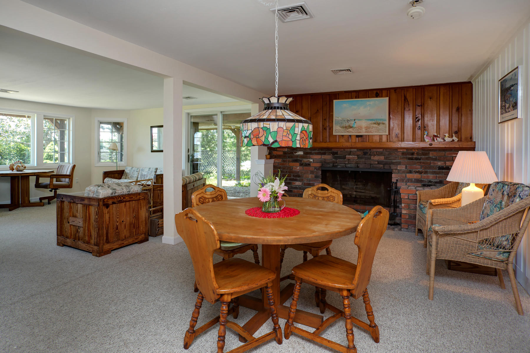 256 Monomoscoy Road Mashpee, MA 02649 - Photo 18 of 28 a living room with furniture a fireplace and a flat screen tv