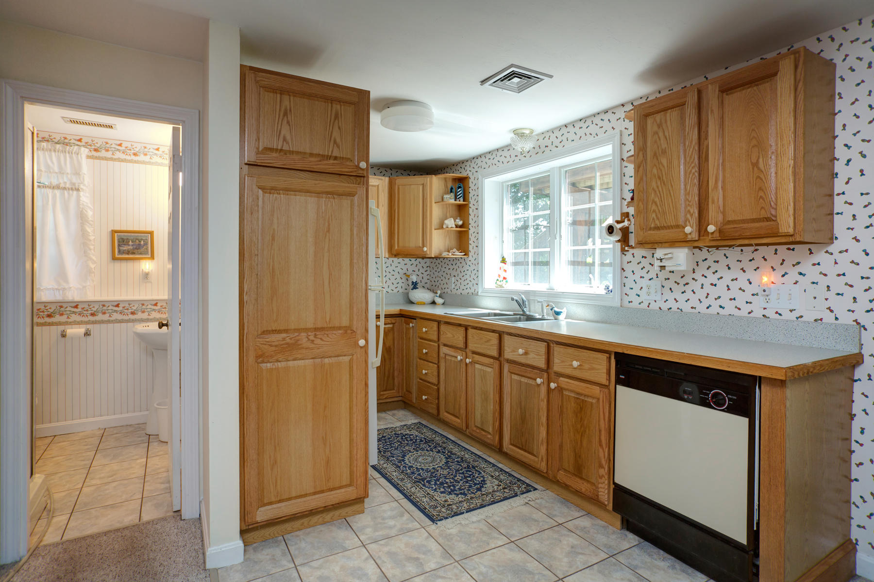 256 Monomoscoy Road Mashpee, MA 02649 - Photo 19 of 28 a kitchen with stainless steel appliances granite countertop a refrigerator and a sink