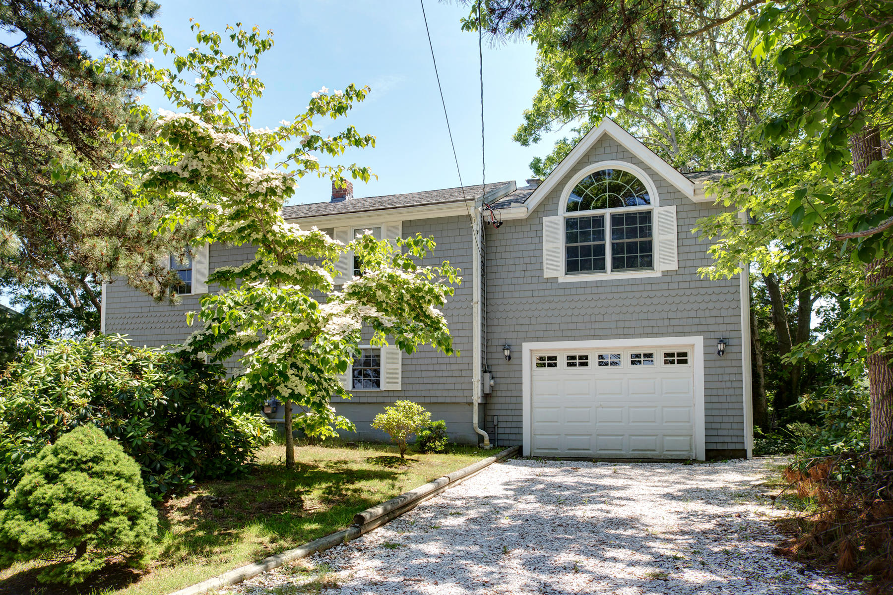256 Monomoscoy Road Mashpee, MA 02649 - Photo 2 of 28 a front view of a house with a garden