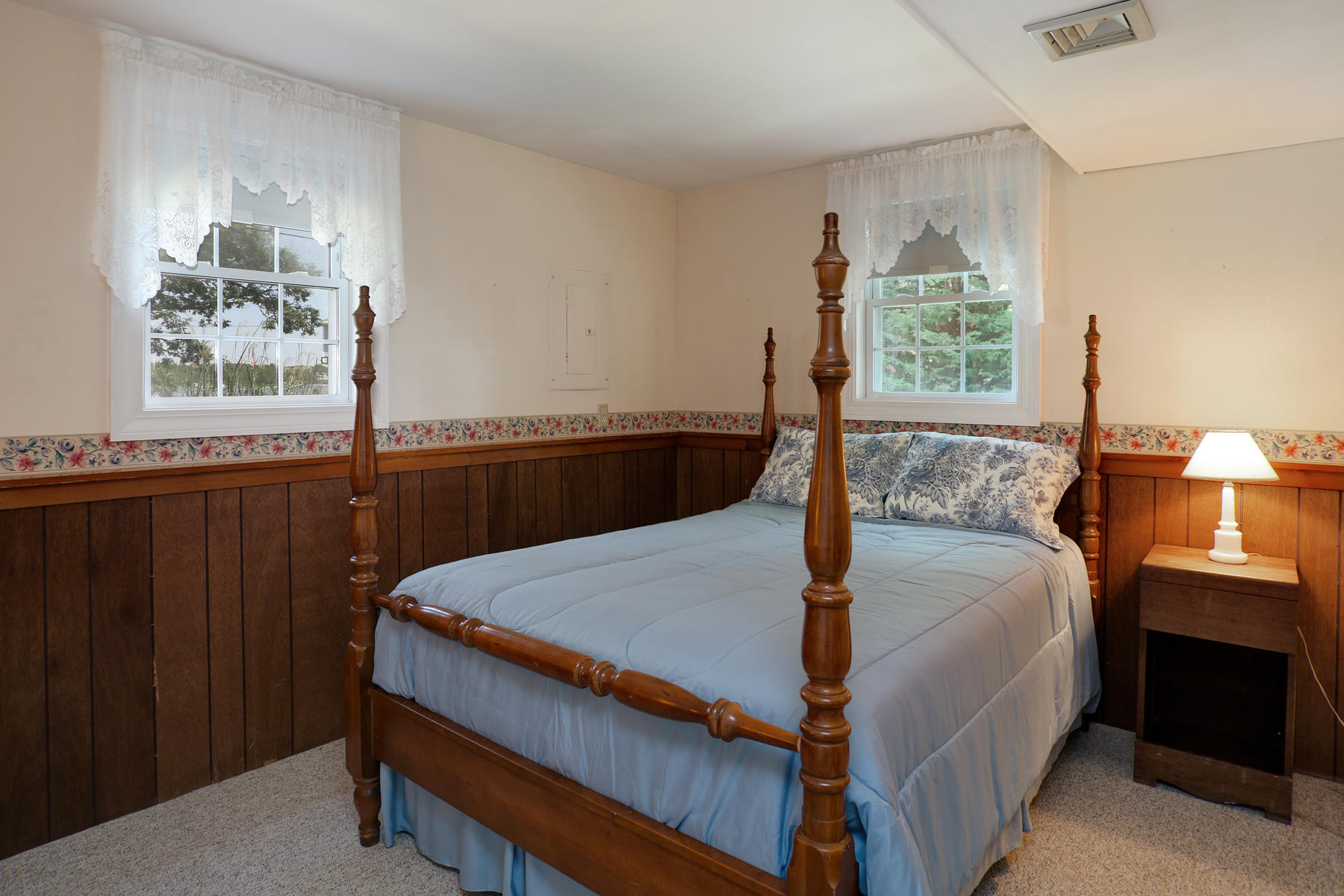 256 Monomoscoy Road Mashpee, MA 02649 - Photo 21 of 28 a bed sitting in a bedroom next to a window