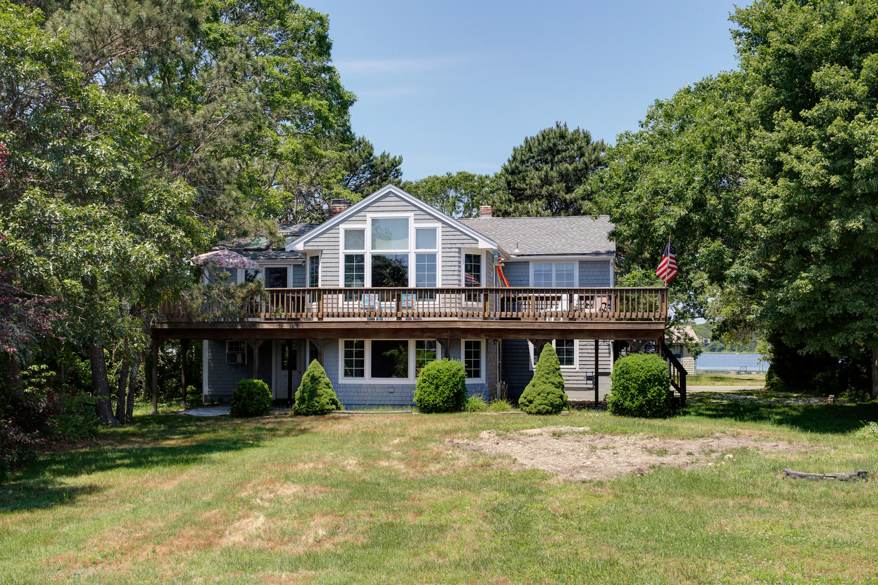256 Monomoscoy Road Mashpee, MA 02649 - Photo 23 of 28 a front view of a house with a yard and potted plants