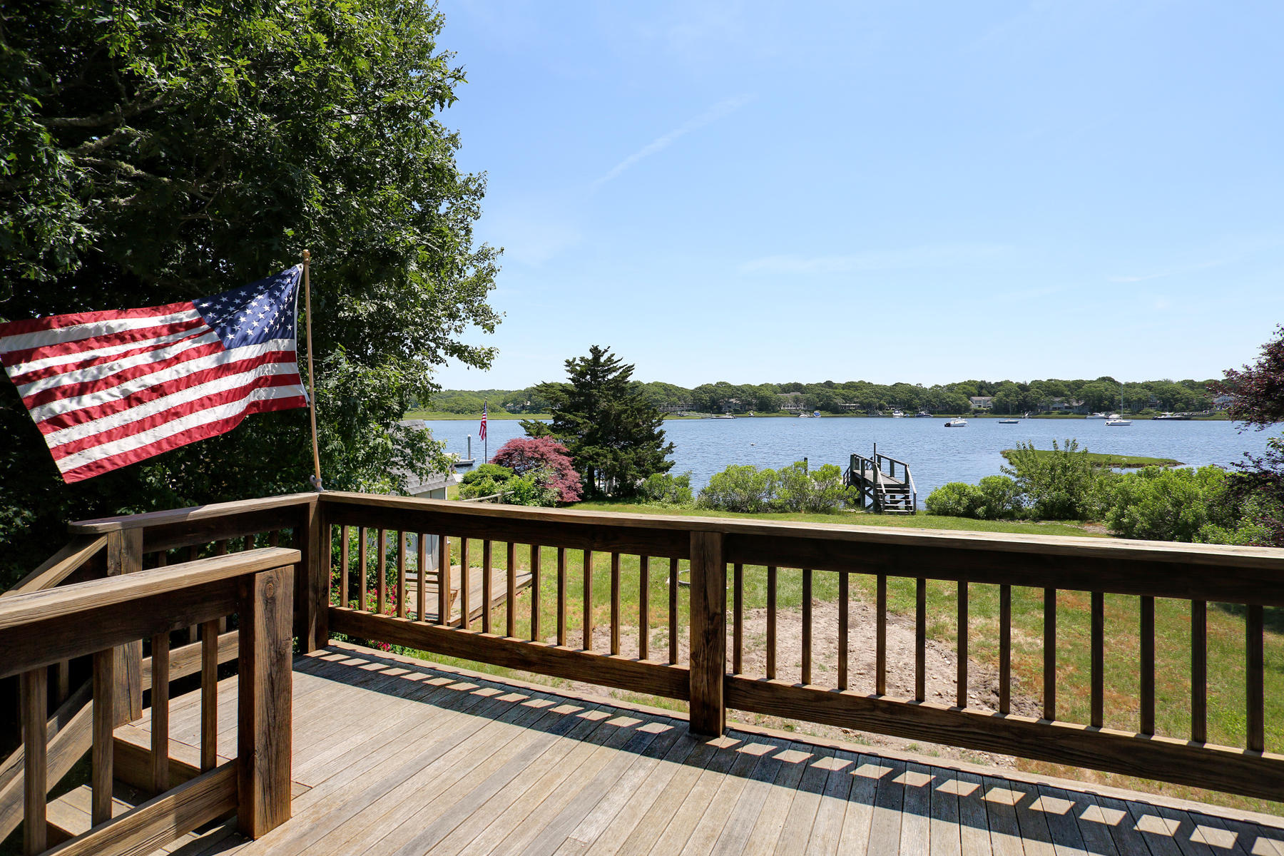 256 Monomoscoy Road Mashpee, MA 02649 - Photo 3 of 28 a view of a balcony with wooden floor and outdoor space