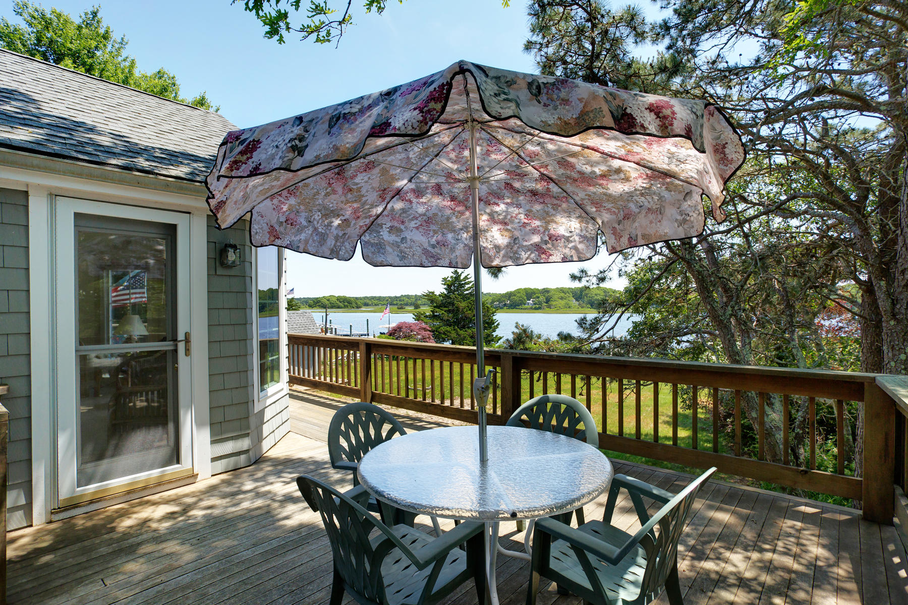 256 Monomoscoy Road Mashpee, MA 02649 - Photo 4 of 28 a view of a balcony with a table and chairs