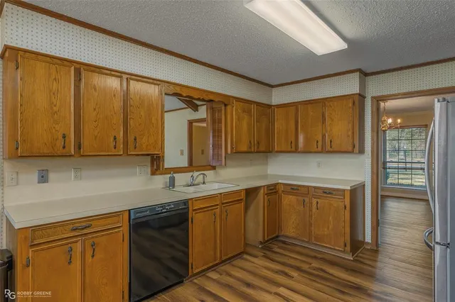a kitchen with a sink cabinets and wooden floor