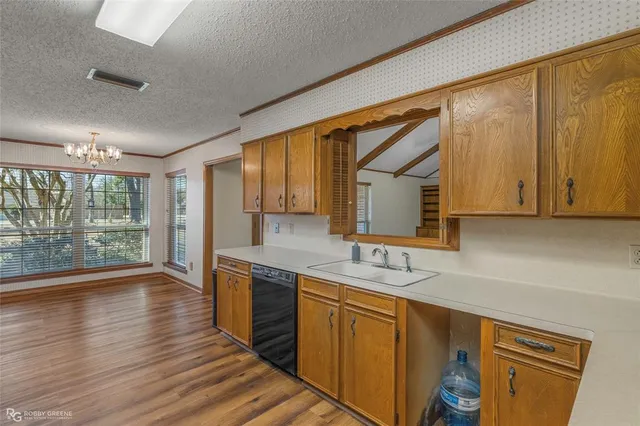 a kitchen with wooden cabinets and sink