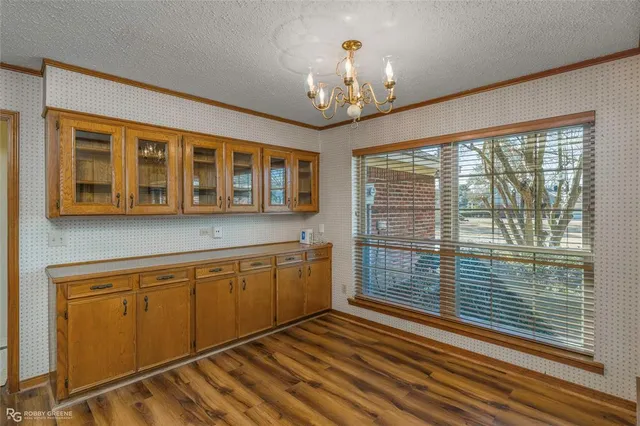 a view of a room with wooden floor and chandelier