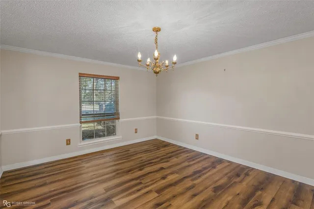 a view of a room with wooden floor and windows