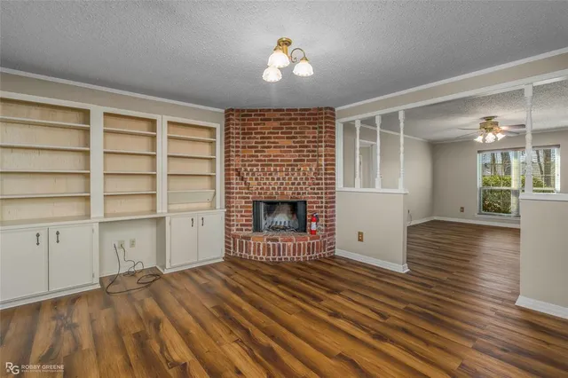 wooden floor fireplace and natural light in room
