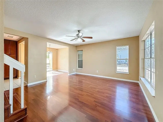a kitchen with granite countertop stainless steel appliances white cabinets sink and a granite counter top
