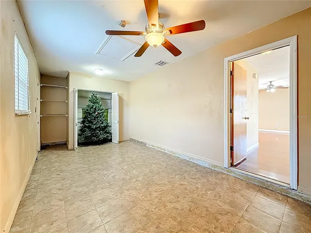 a view of a big room with a ceiling fan
