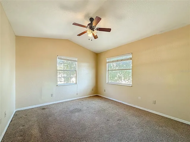 an aerial view of a house with a yard and garden
