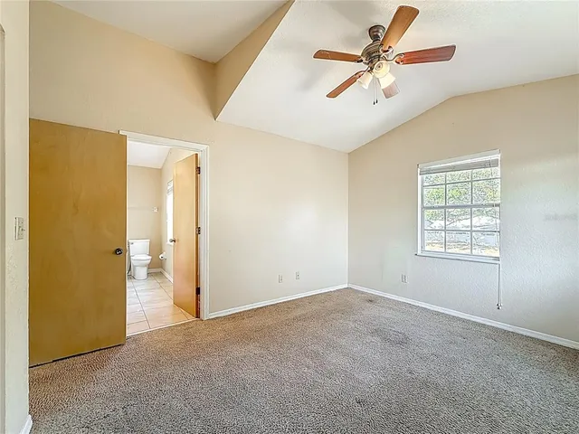 an aerial view of house with yard and mountain view in back