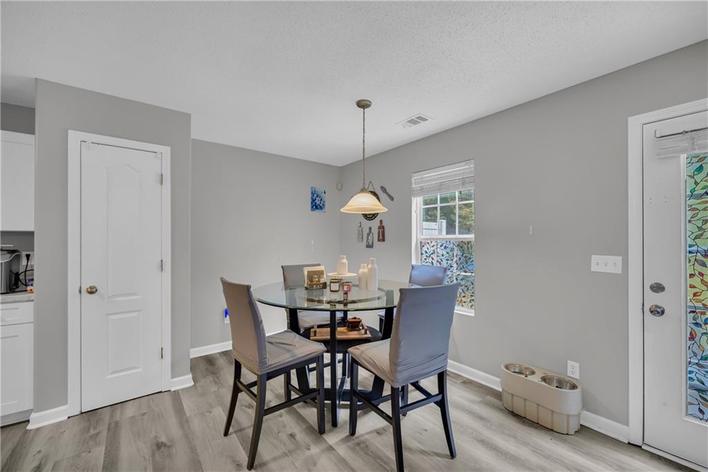 1498 Box Circle Winder, GA 30680 - Photo 19 of 56 a view of a dining room with furniture and wooden floor