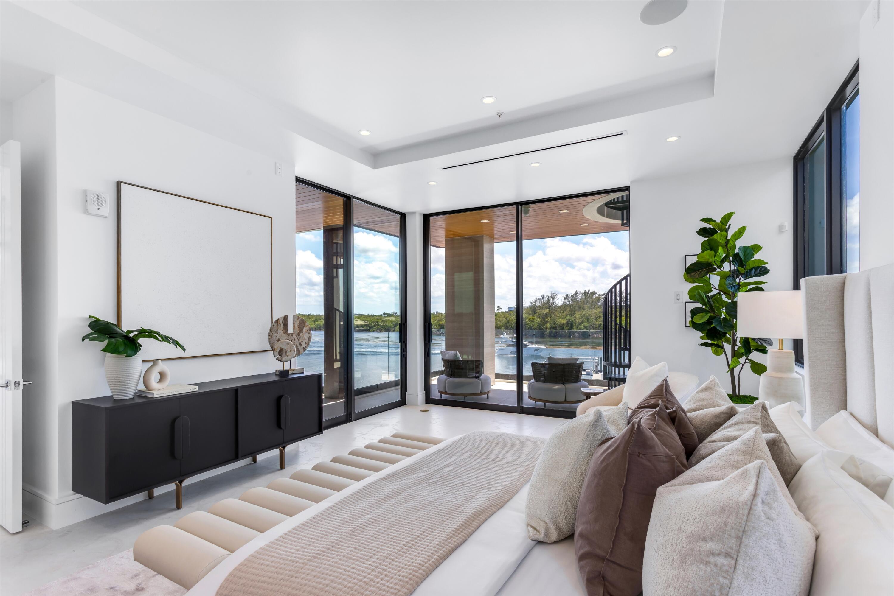 900 Lago Mar Lane, Unit PH Boca Raton, FL 33431 - Photo 22 of 58 a bed room with a bed and a large window