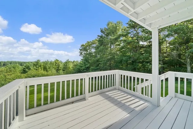 a balcony with wooden floor and outdoor space