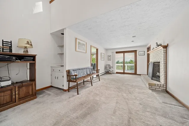 a living room with furniture a flat tv screen and a fireplace