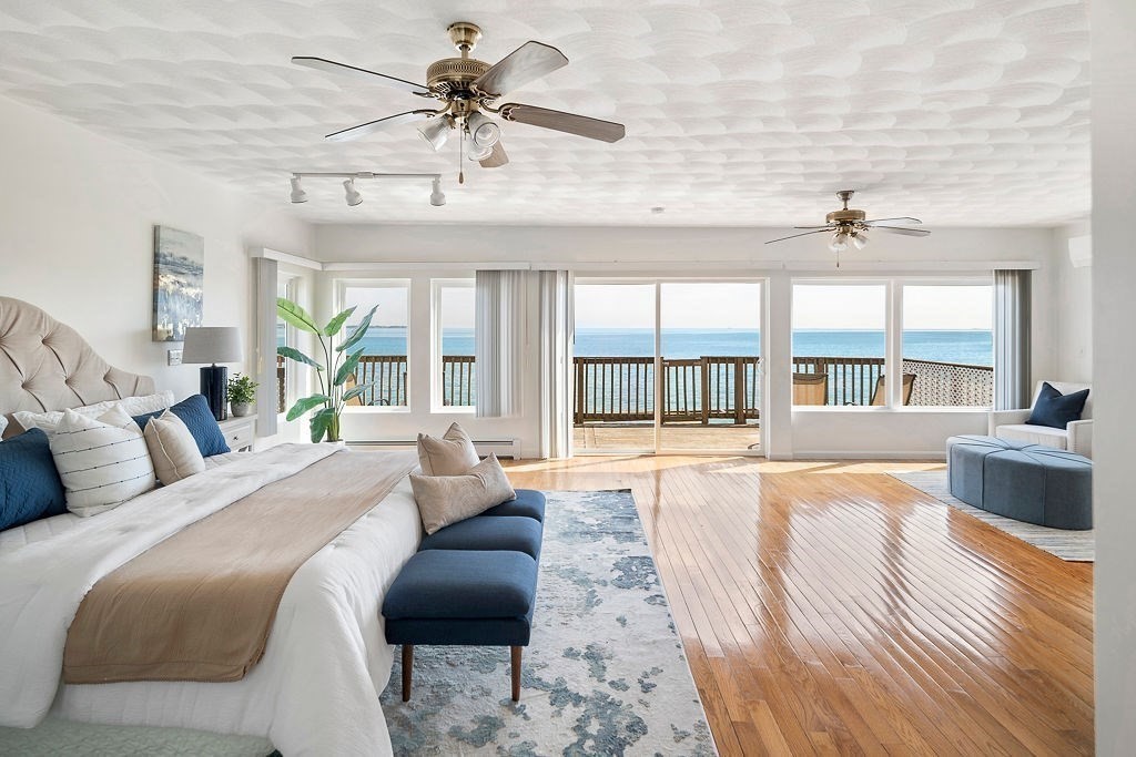 1 Spray Avenue Revere, MA 02151 - Photo 1 of 36 a large bedroom with a large bed a chandelier and windows