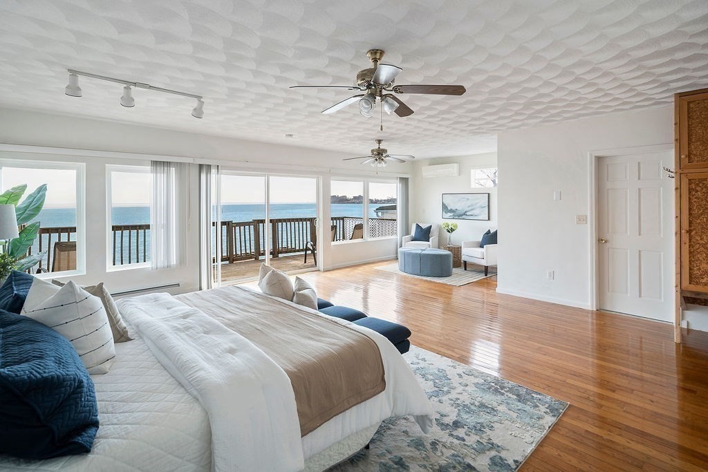 1 Spray Avenue Revere, MA 02151 - Photo 13 of 36 a spacious bedroom with a large bed and a chandelier