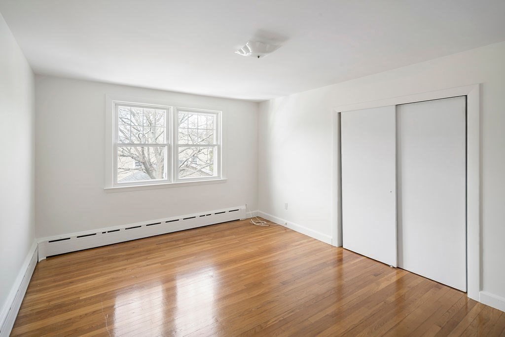 1 Spray Avenue Revere, MA 02151 - Photo 18 of 36 an empty room with wooden floor and windows