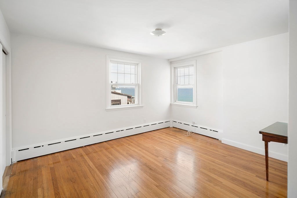 1 Spray Avenue Revere, MA 02151 - Photo 21 of 36 an empty room with wooden floor and windows