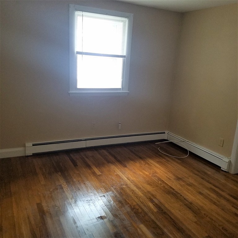 1 Spray Avenue Revere, MA 02151 - Photo 30 of 36 an empty room with wooden floor and windows