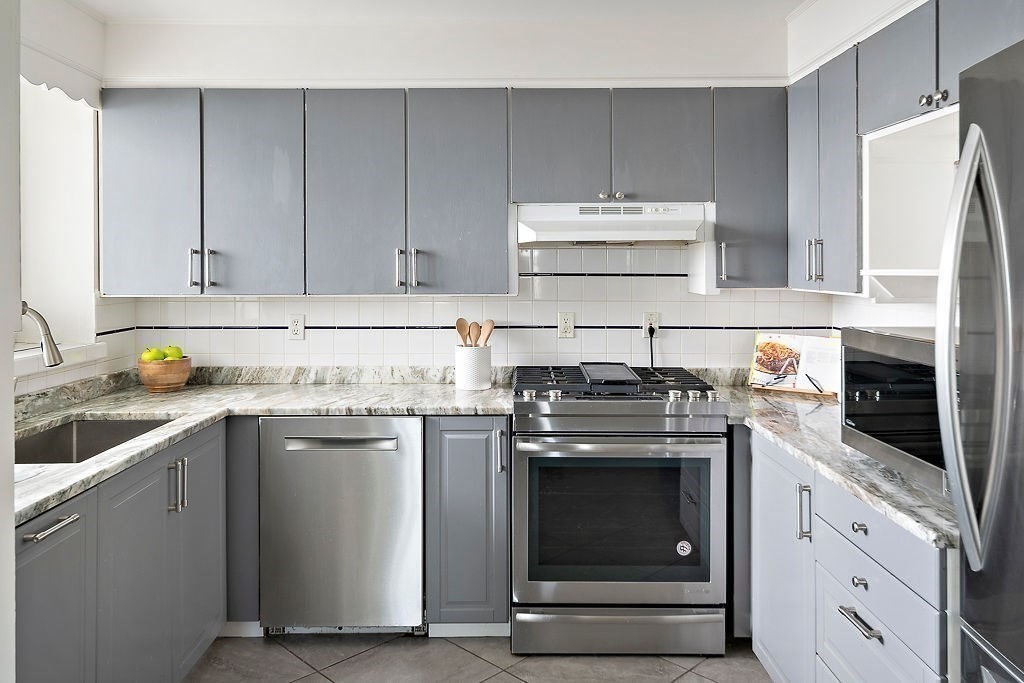1 Spray Avenue Revere, MA 02151 - Photo 6 of 36 a kitchen with cabinets appliances and a sink