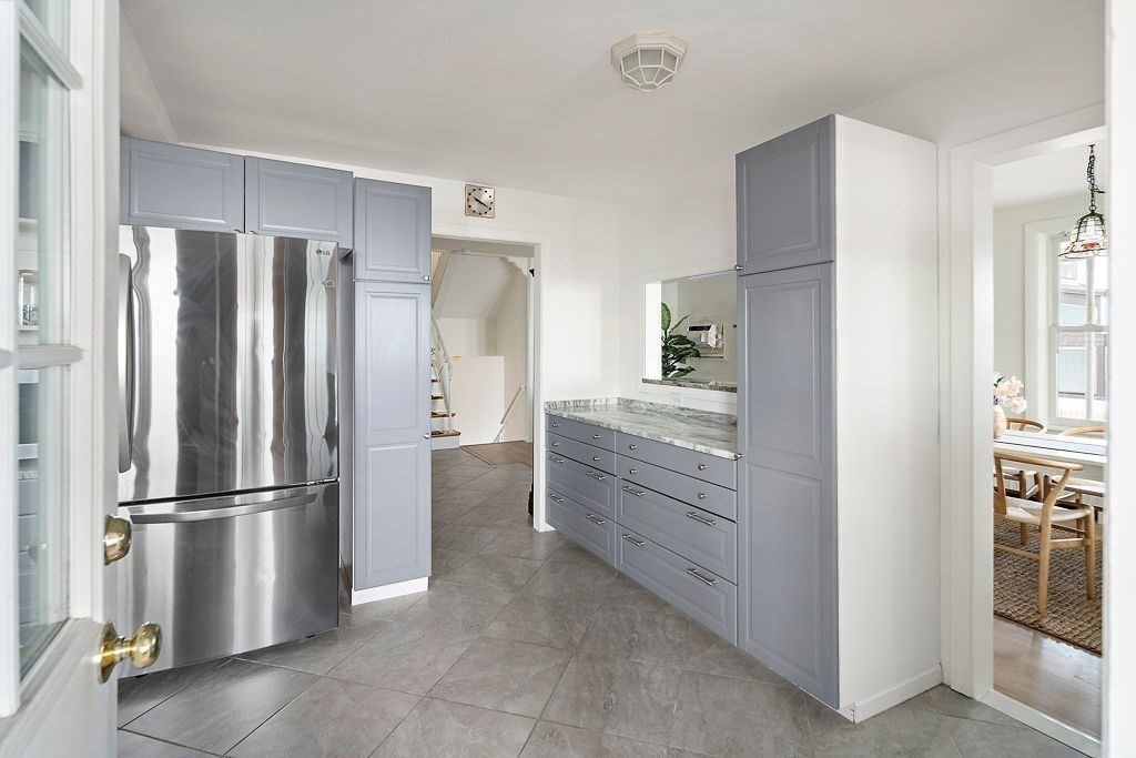 1 Spray Avenue Revere, MA 02151 - Photo 7 of 36 a kitchen with white cabinets and stainless steel appliances