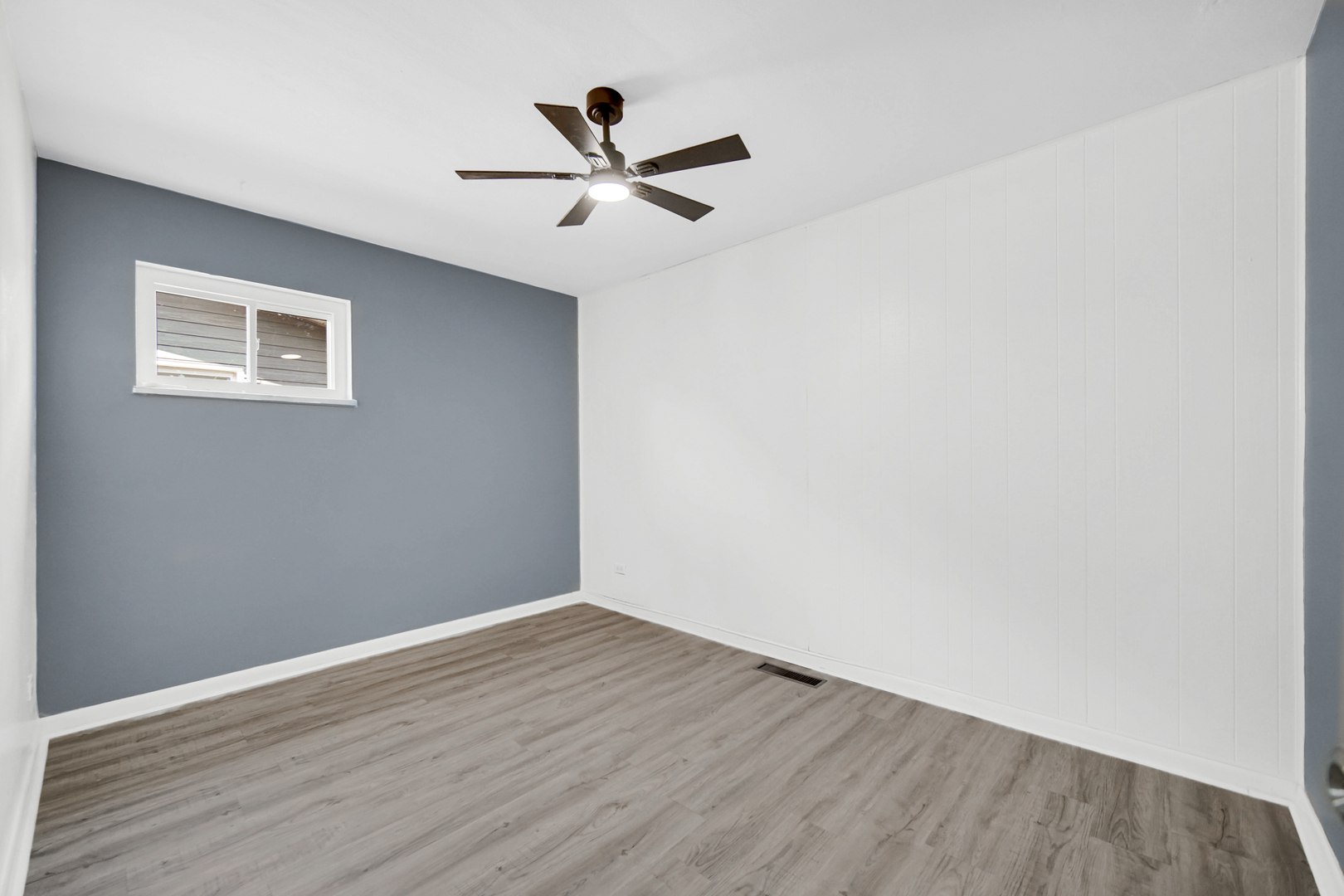 1455 Burnham Avenue Calumet City, IL 60409 - Photo 12 of 20 a view of a big room with wooden floor and closet