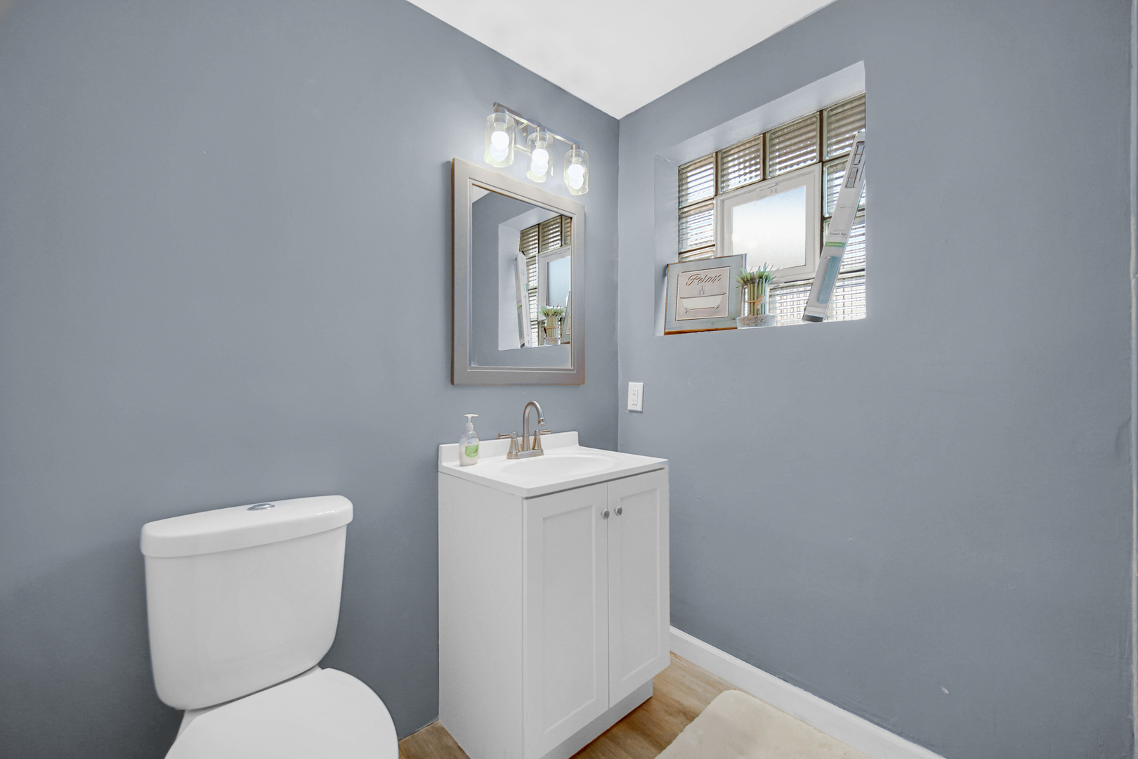 1455 Burnham Avenue Calumet City, IL 60409 - Photo 14 of 20 a bathroom with a toilet sink and mirror