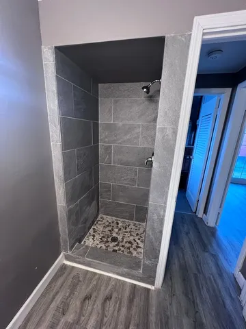 a bathroom with a glass door shower