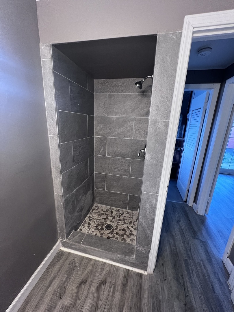 1455 Burnham Avenue Calumet City, IL 60409 - Photo 15 of 20 a bathroom with a glass door shower