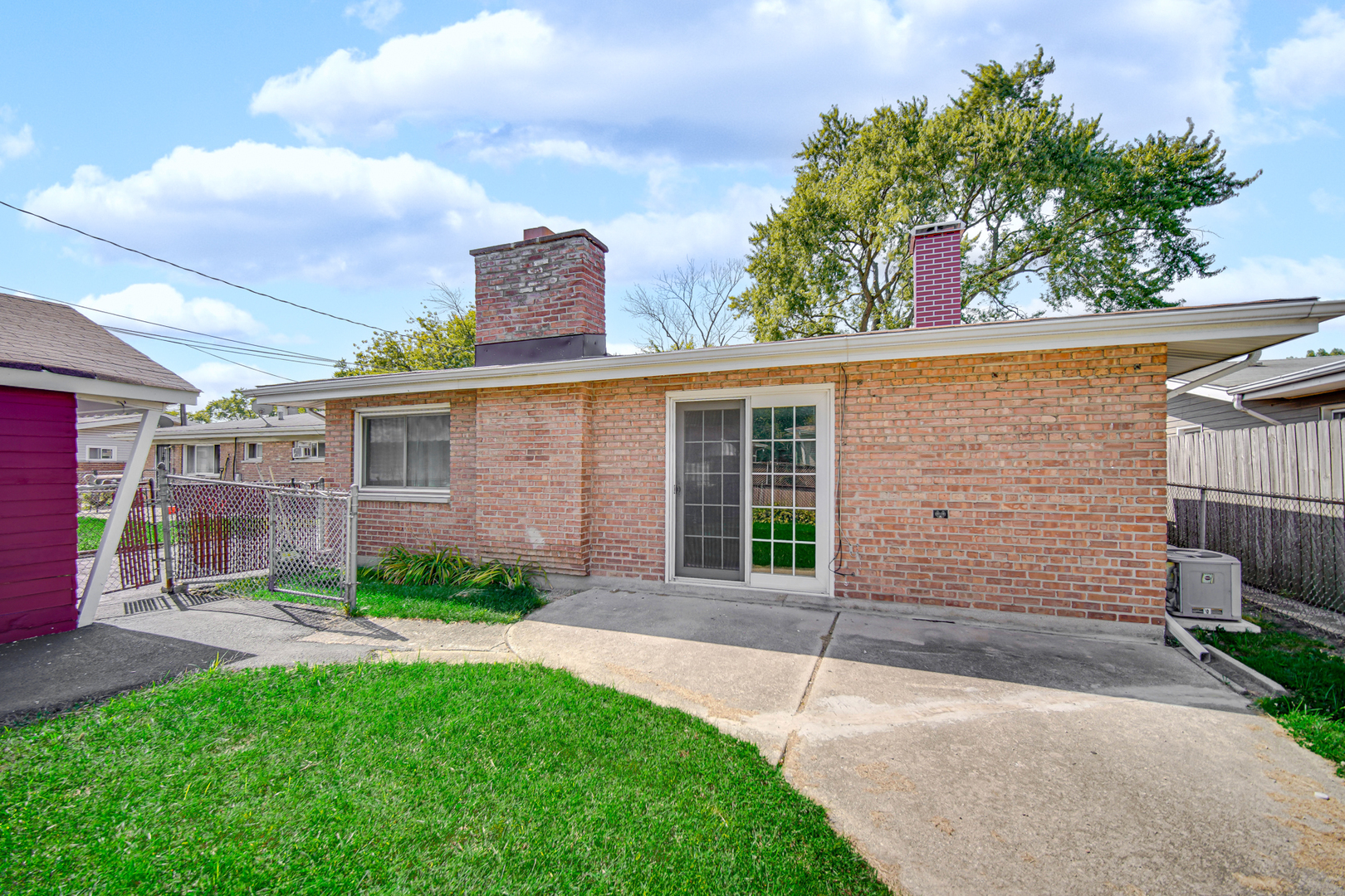 1455 Burnham Avenue Calumet City, IL 60409 - Photo 19 of 20 a view of a house with a yard and potted plants