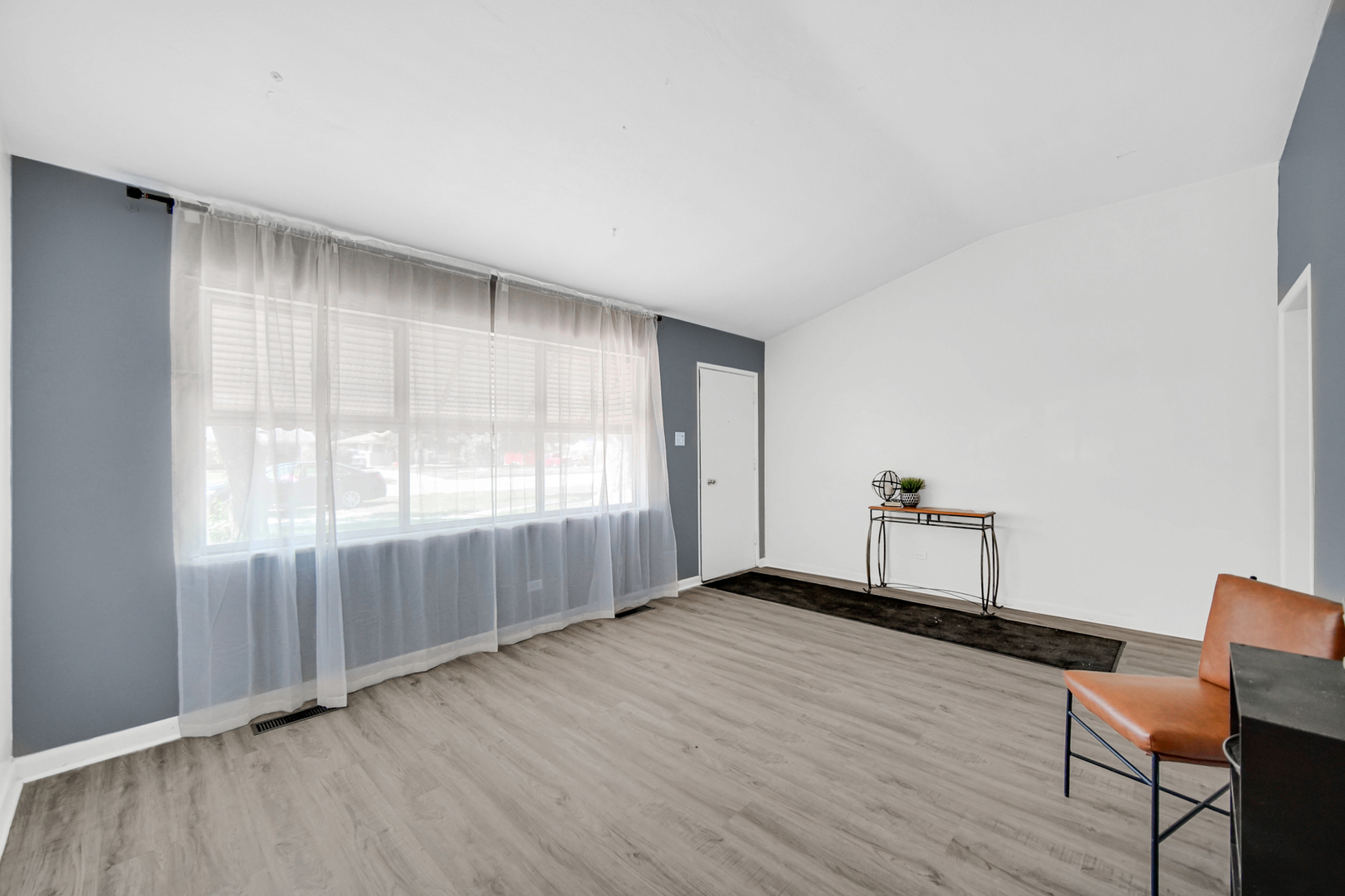 1455 Burnham Avenue Calumet City, IL 60409 - Photo 2 of 20 an empty room with wooden floor and windows