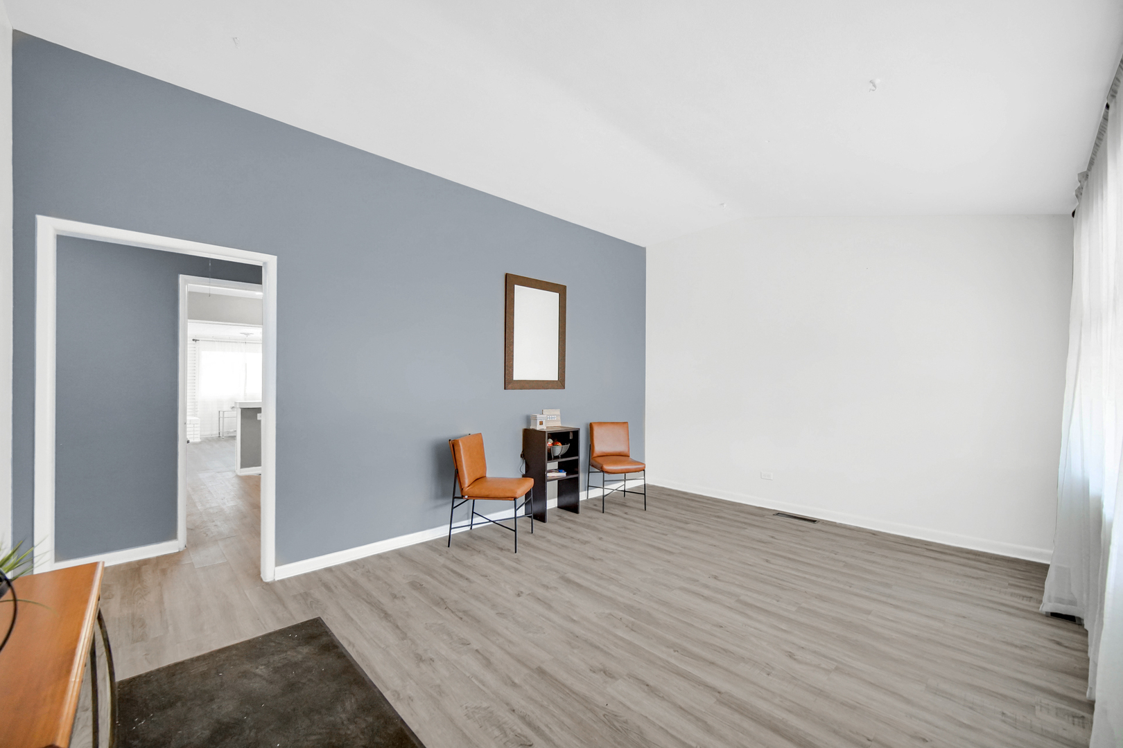 1455 Burnham Avenue Calumet City, IL 60409 - Photo 3 of 20 a view of a livingroom with wooden floor and a bench