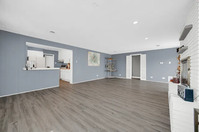 a view of a room with wooden floor and windows