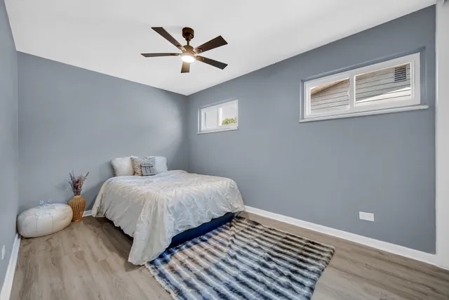a bedroom with a bed and painting on the wall