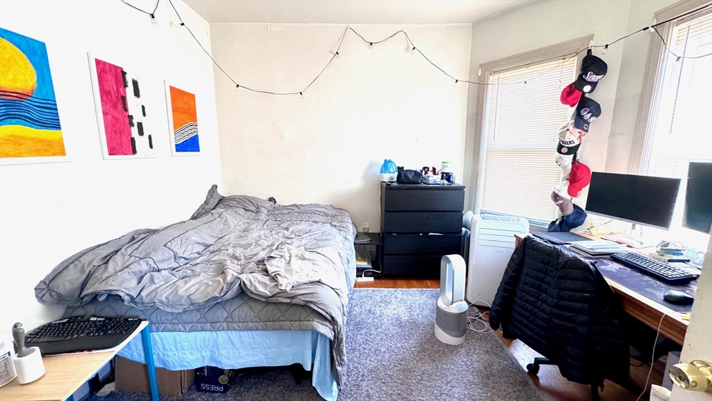 a bedroom with a bed and a workspace