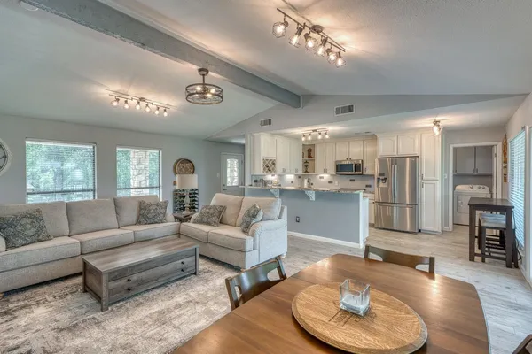 a kitchen with refrigerator cabinets and wooden floor