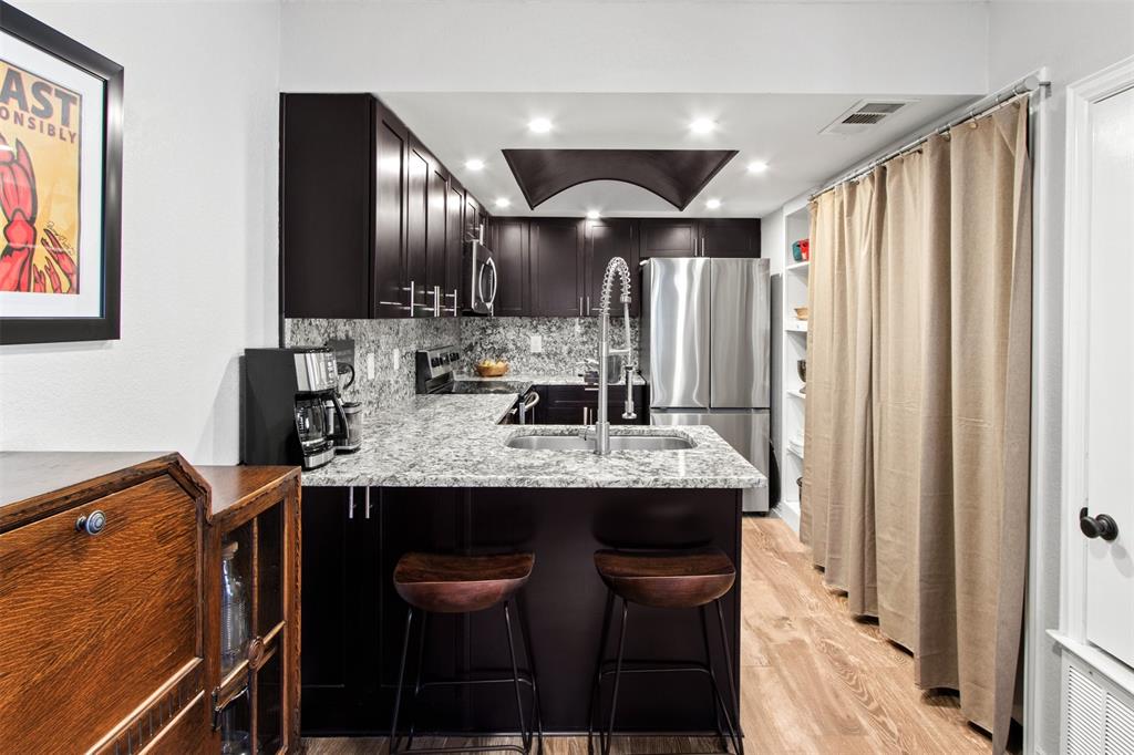 18040 Midway Road, Unit 103 Dallas, TX 75287 - Photo 7 of 37 a kitchen with stainless steel appliances granite countertop counter space a sink and cabinets