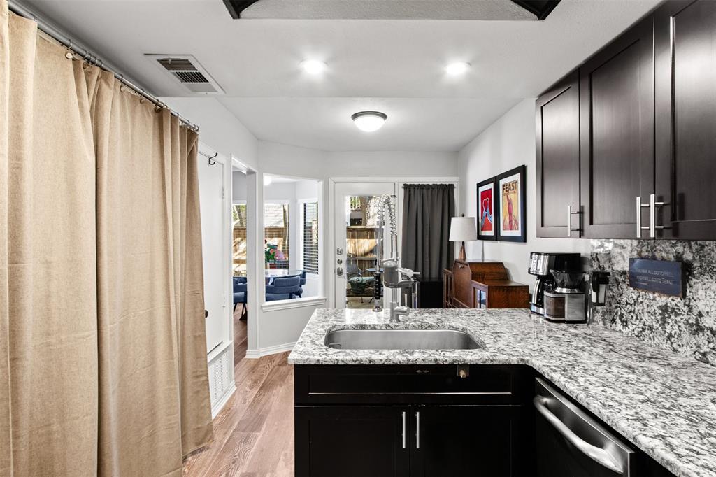 18040 Midway Road, Unit 103 Dallas, TX 75287 - Photo 9 of 38 a kitchen with stainless steel appliances granite countertop a sink and cabinets