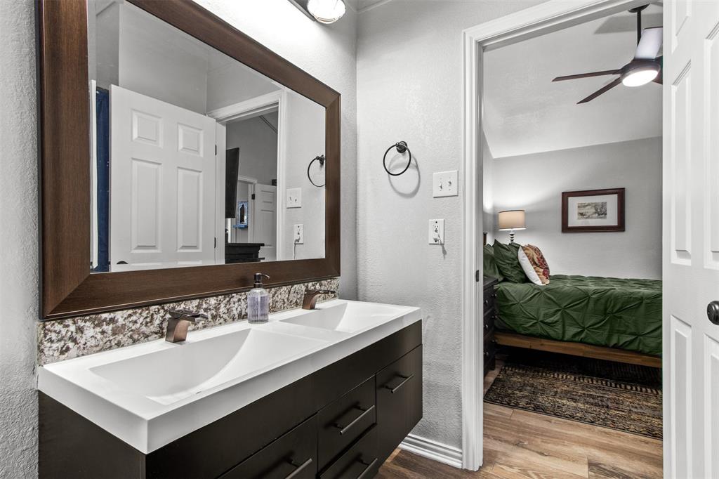 18040 Midway Road, Unit 103 Dallas, TX 75287 - Photo 13 of 37 a bathroom with a sink and a mirror
