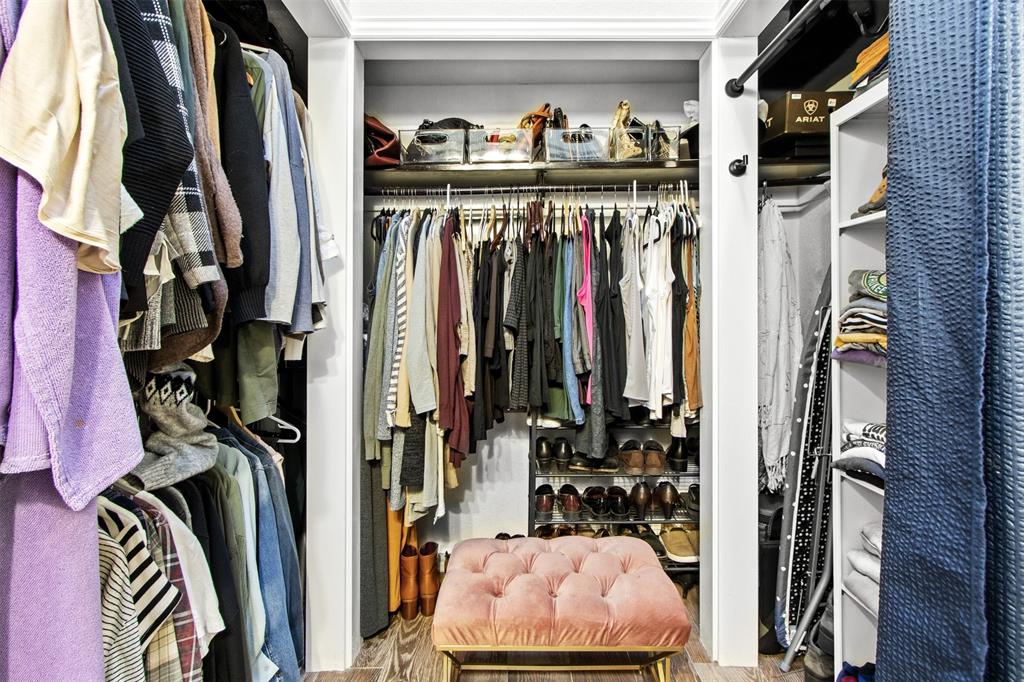 18040 Midway Road, Unit 103 Dallas, TX 75287 - Photo 14 of 37 a view of walk in closet with clothes and shoes