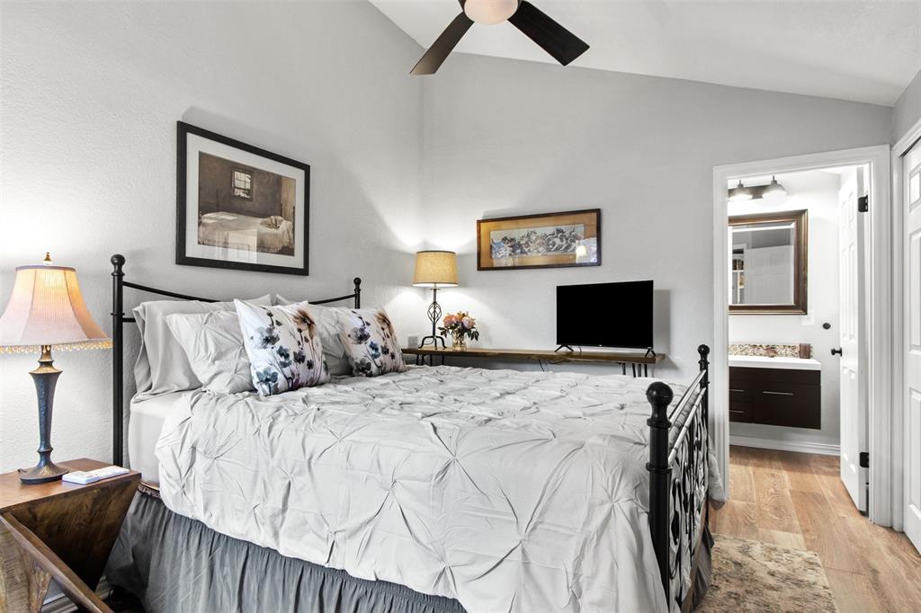 18040 Midway Road, Unit 103 Dallas, TX 75287 - Photo 18 of 37 a bedroom with a bed and a television