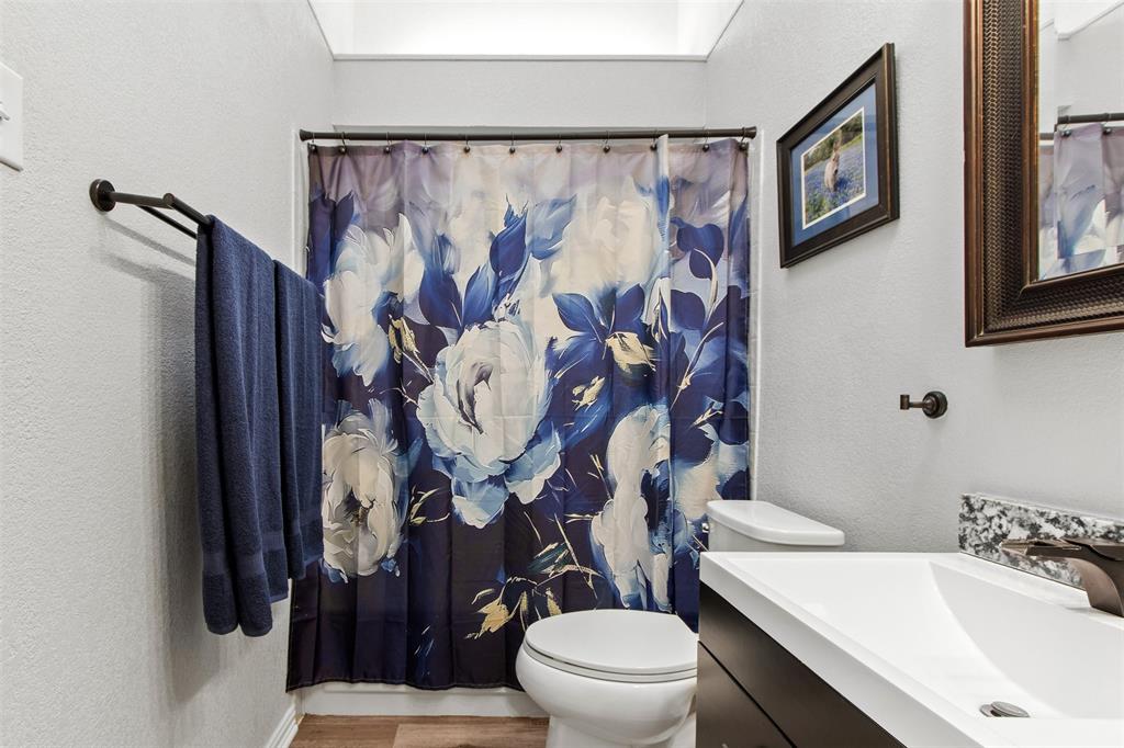 18040 Midway Road, Unit 103 Dallas, TX 75287 - Photo 21 of 38 a white toilet sitting next to a bathroom sink